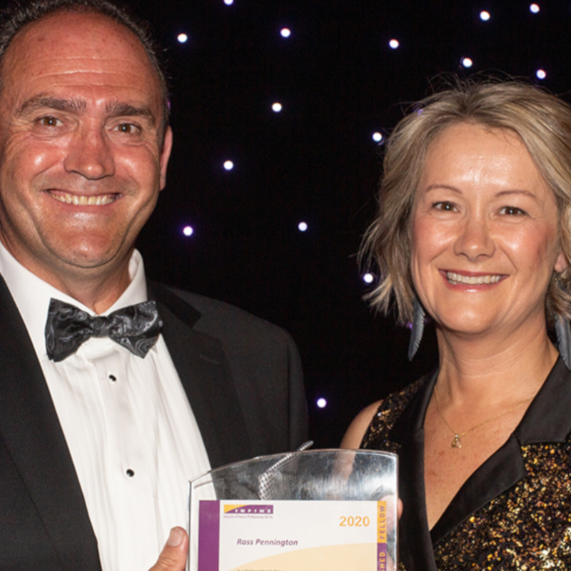 two people smiling with their award 